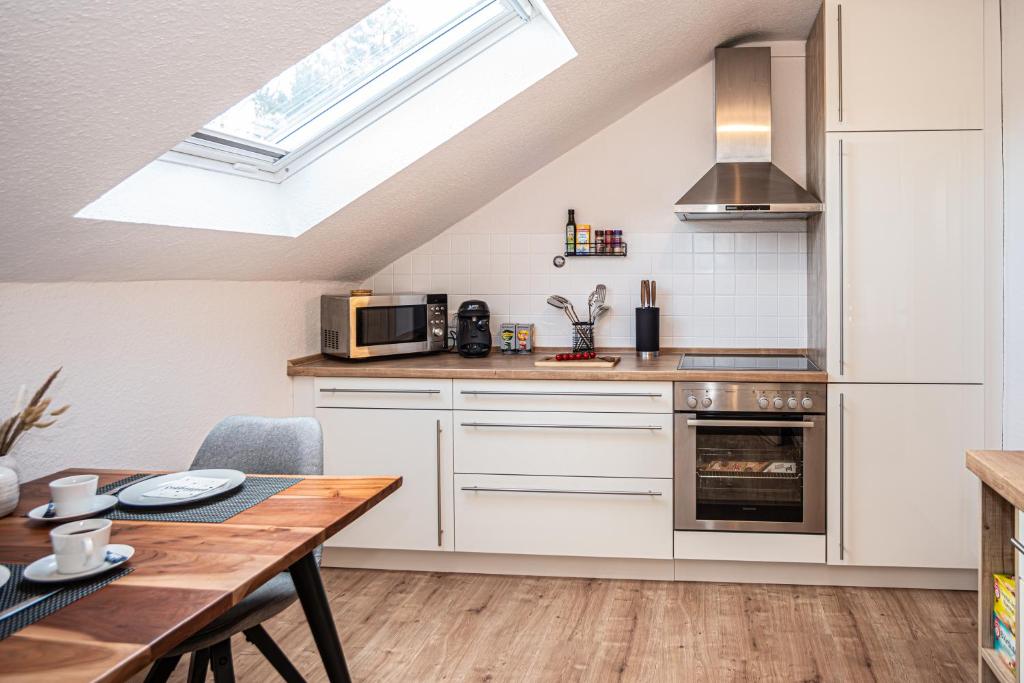 a kitchen with a dining table and a skylight at Neue Ferienwohnung in Marl in Marl