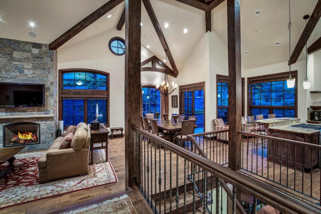 a living room with a fireplace and a dining room at Woodrun Place in Snowmass Village