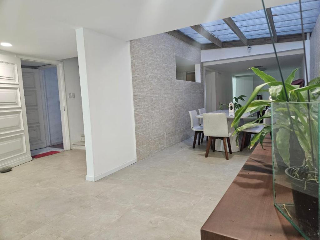 a living room with a table and some plants at Espaço Semente Solar Jade in Porto Alegre