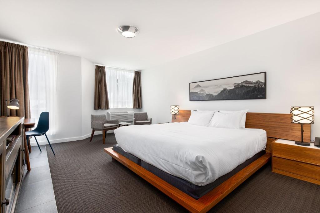 a hotel room with a bed and a desk at Adara Hotel in Whistler