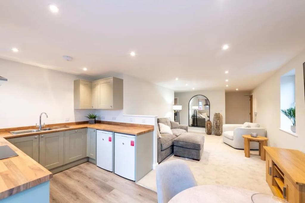 an open kitchen and living room with a couch at *Luxury Apartment 2min from City in Carlisle