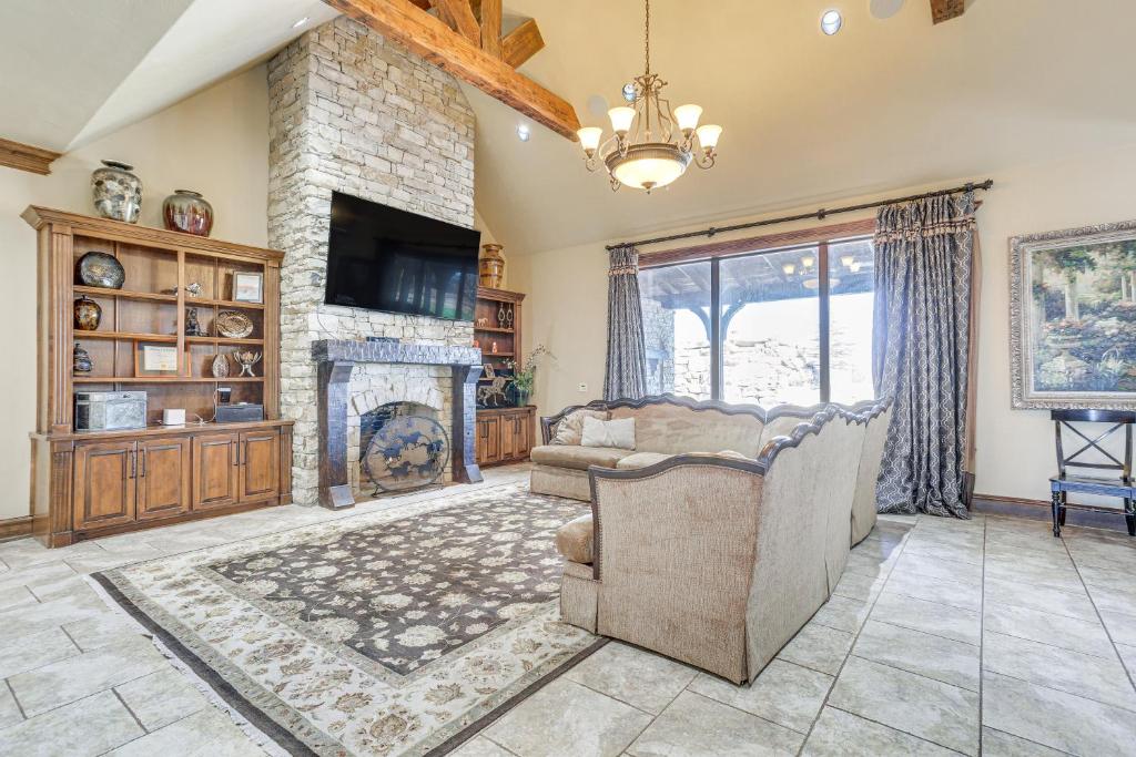 a living room with a couch and a fireplace at Spacious Edmond Vacation Rental with Shared Pool! in Edmond