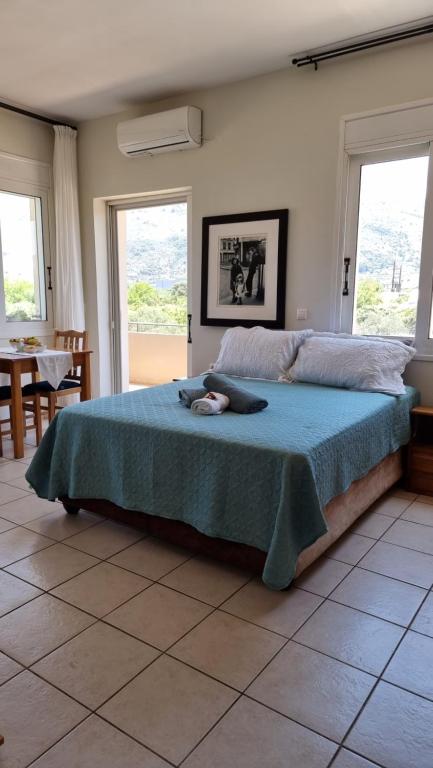 a bedroom with a bed with a cat laying on it at Chania Homely Apartments in Souda
