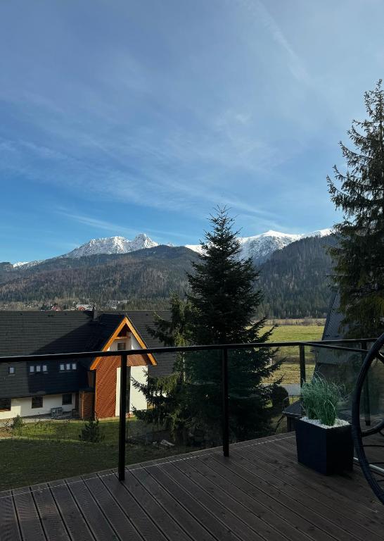 a view of mountains from the deck of a house at Apartament Magiczne Podhale by Apart Concept Podhale in Kościelisko