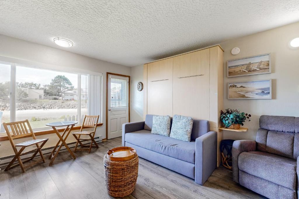 a living room with a couch and a chair and a table at Little Slice of Heaven in Neskowin