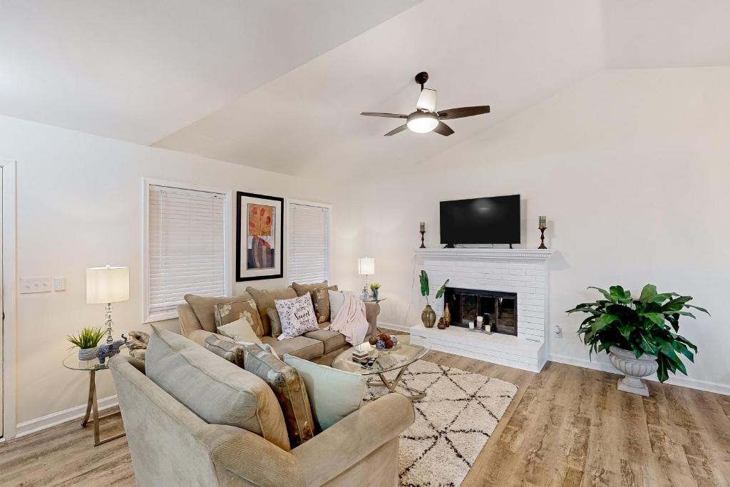 a living room with a couch and a fireplace at A Peaceful Place in Kennesaw