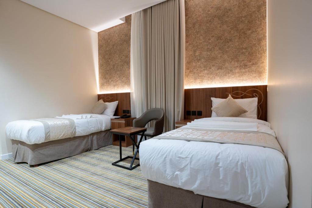 Postel nebo postele na pokoji v ubytování Rawha Al Maqam Ajyad Hotel