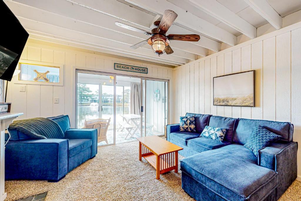 a living room with blue couches and a ceiling fan at Mallard Lakes --- 38287 Cardinal Ln Unit 134 in Selbyville
