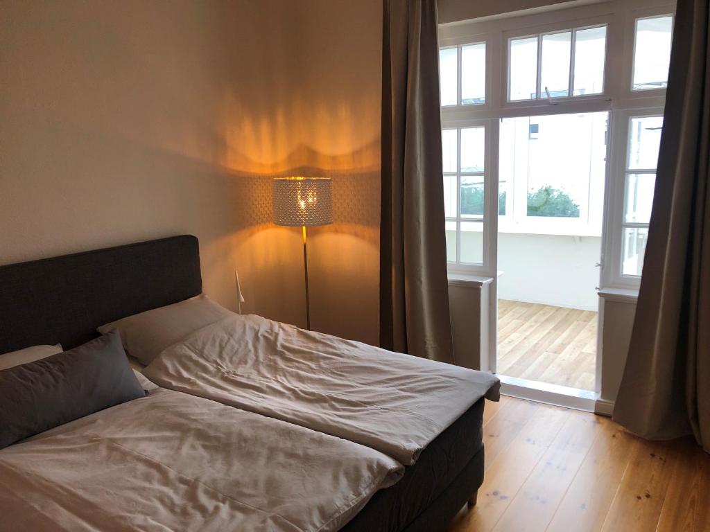 a bedroom with a bed and a large window at Ferienhaus ON90 in Wilhelmshaven