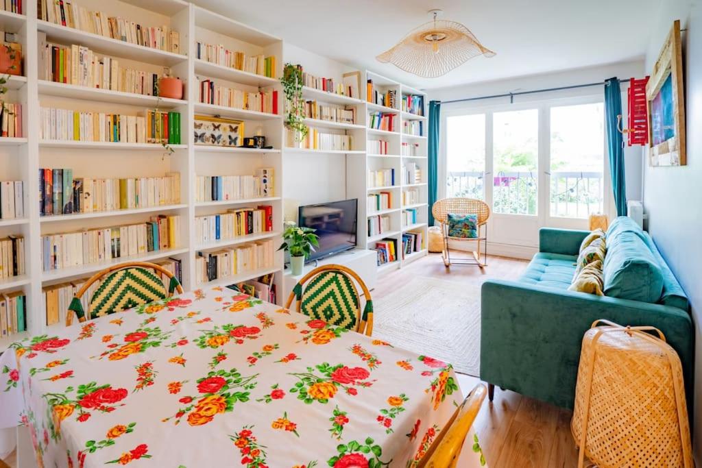 - un salon avec un lit et des étagères dans l'établissement Jolie nid familiale, à Paris