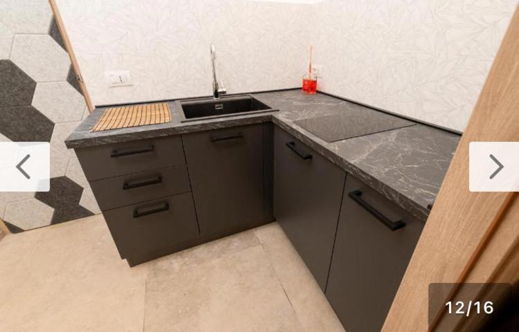 a kitchen with a sink and a counter top at Santa Lucia Affittacamere in Gioia del Colle