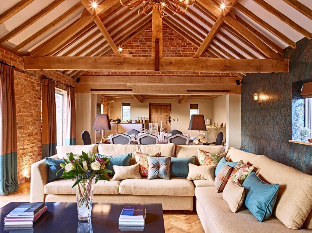 a living room with a couch and a table at The Stables in Ledbury