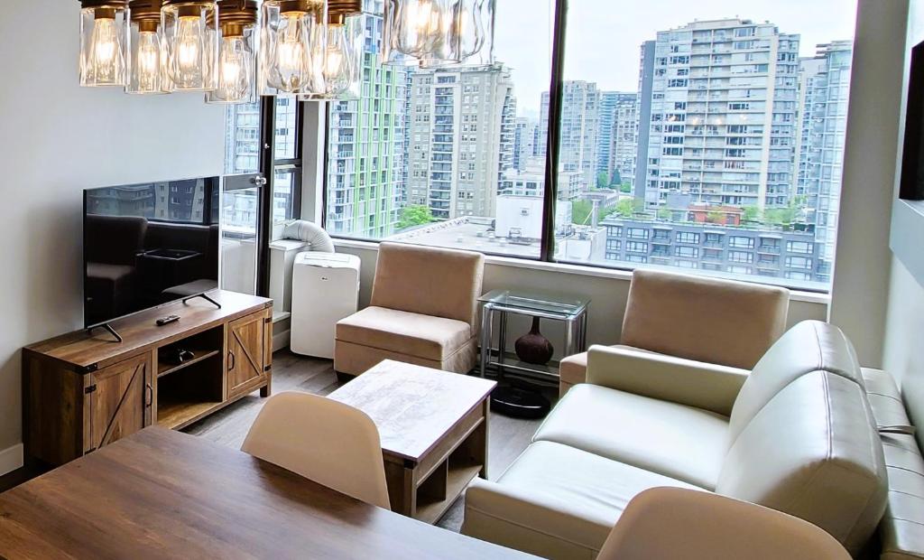 a living room with a view of a city at Howe Street Apartment with Views in Vancouver