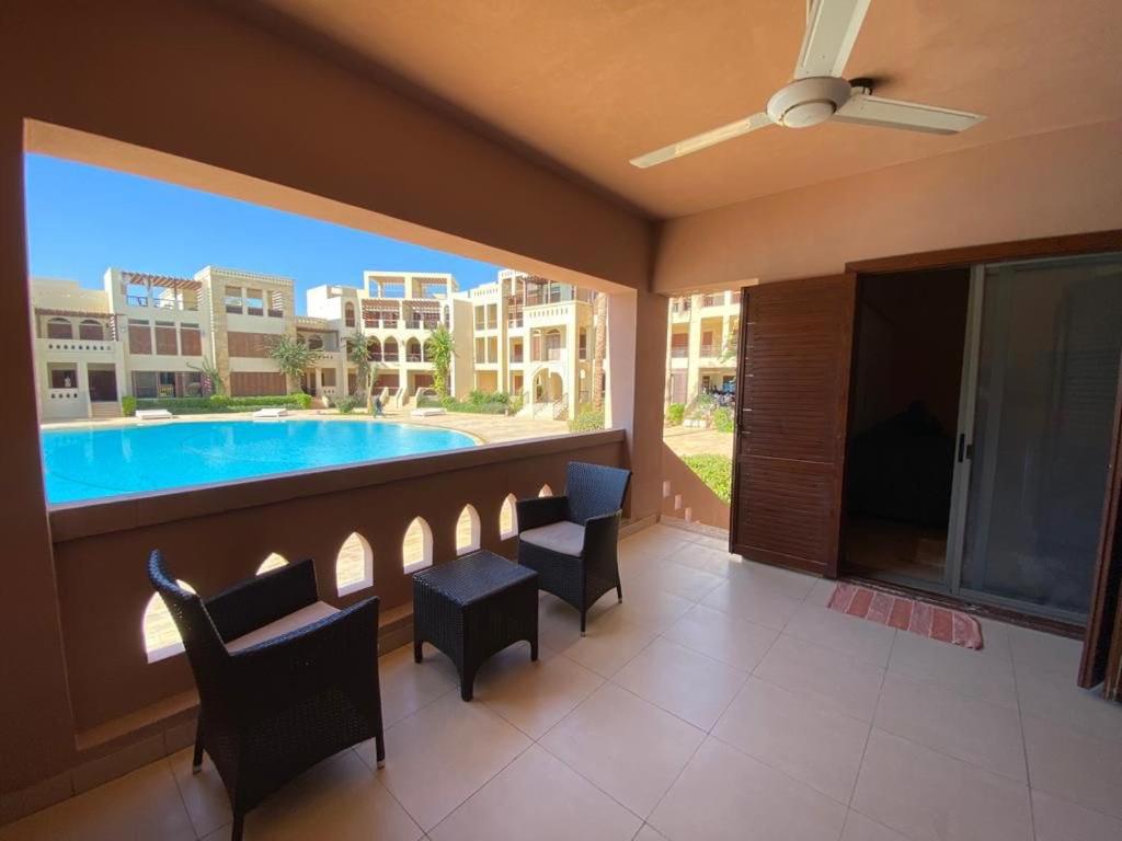 a balcony with a view of a swimming pool at شقة مطلة على بركة سباحه in Al Burj