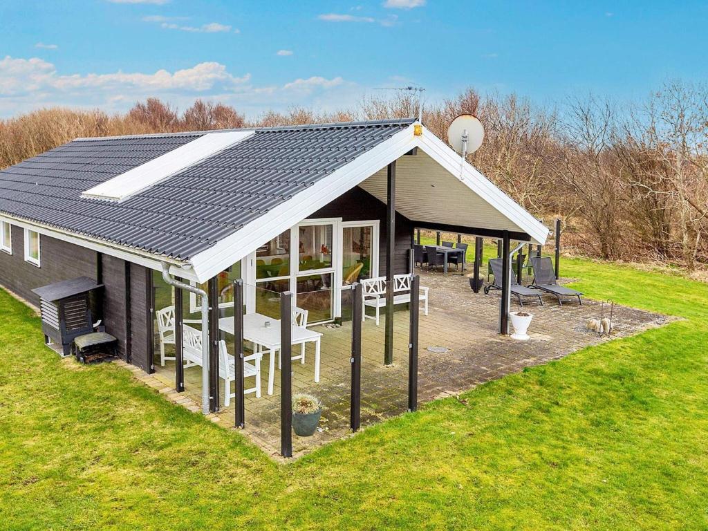 a house with a pitched roof with a picnic table at Holiday home Vinderup XXVI in Vinderup