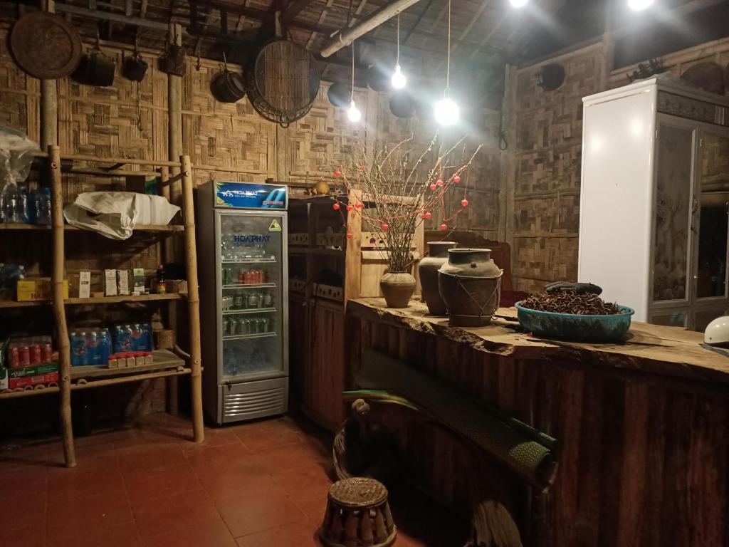 a room with a refrigerator and a counter with drinks at Puluong homestay nacoLodge in Làng Chiêu