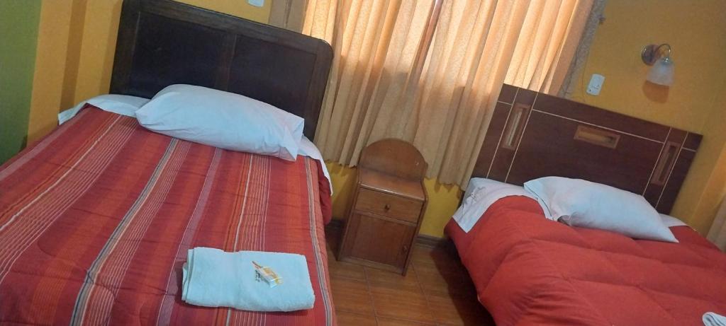 Postel nebo postele na pokoji v ubytování HOSTAL JOYA ANDINA