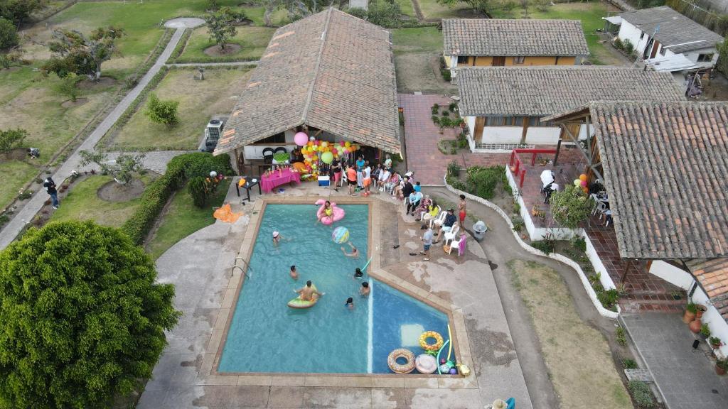 an overhead view of a large swimming pool with people at Quinta Suria in Quito