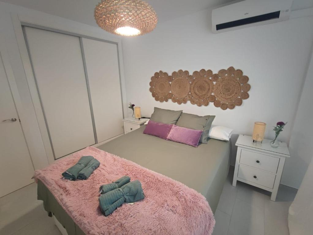 1 dormitorio con 1 cama con 2 toallas en Apartamento Pilar, en Sevilla