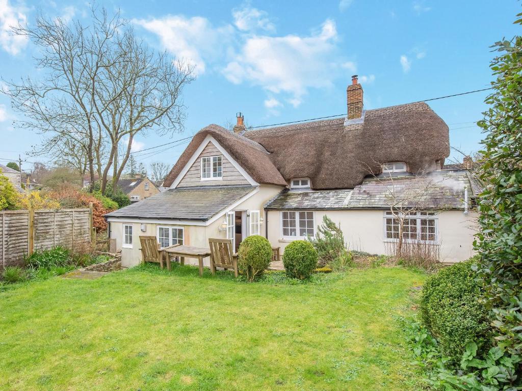 a large white house with a thatched roof at Jasmine Cottage in Osmington