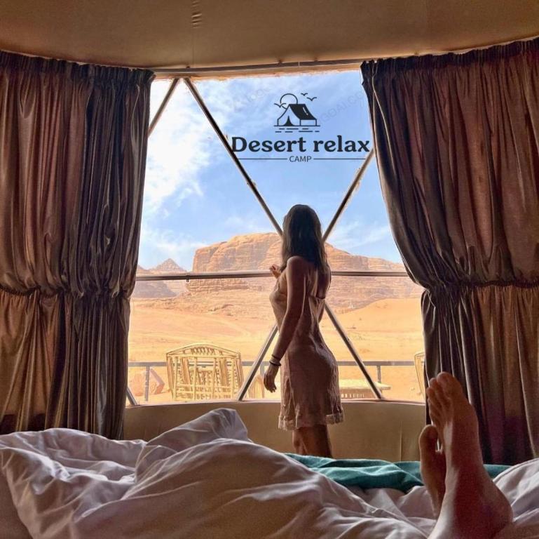 a woman looking out the window of a desert train at Desert relax camp in Wadi Rum