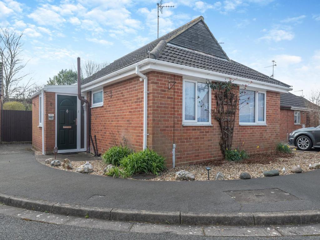 a red brick house with a black door at Goose Green House in Sutton Bridge