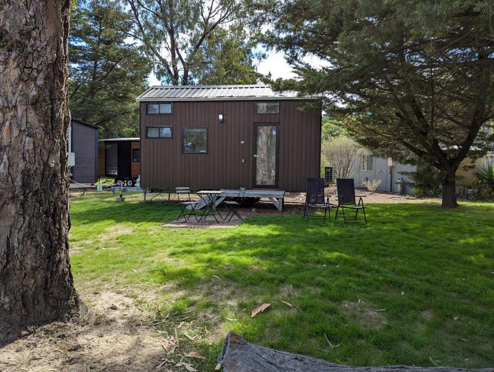 a tiny house with a picnic table in a yard at M13 Tiny House at Grampians Edge in Dadswells Bridge