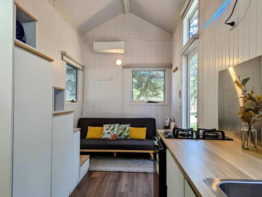 a kitchen and living room of a tiny house at Tiny House 20 at Grampians Edge in Dadswells Bridge