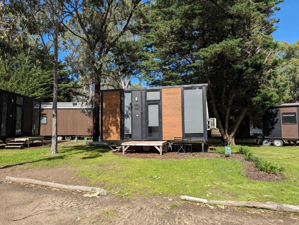 a tiny house with a picnic table and trees at Tiny House 14 at Grampians Edge in Dadswells Bridge