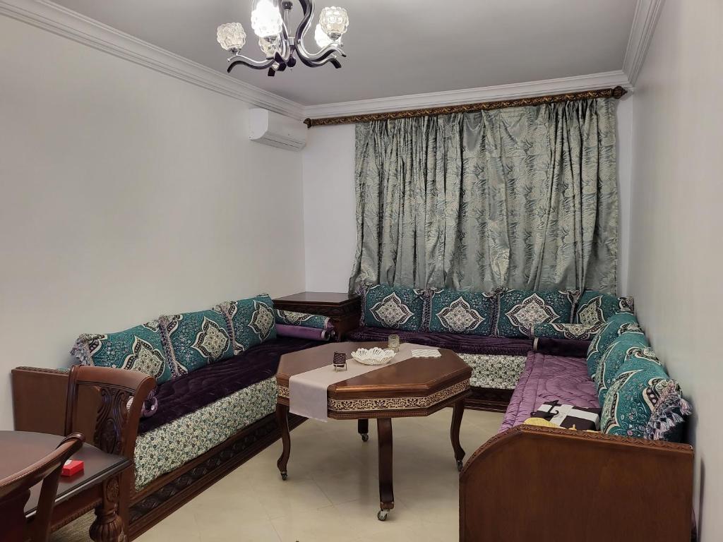 a living room with a couch and a table at Zemmouri 3 in Tangier