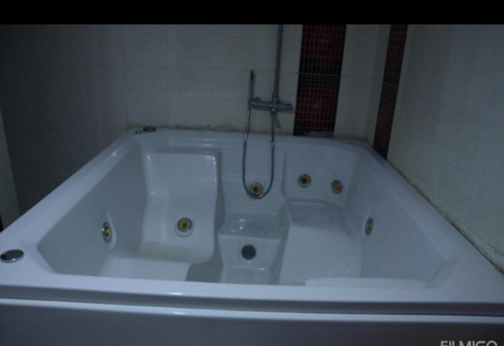 a white bath tub in a bathroom at قصر 6غرف حمام سباحه in 6th Of October