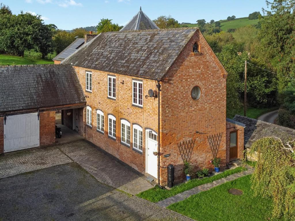 an aerial view of a brick building with a garage at The Annex At Is Y Coed in Welshpool