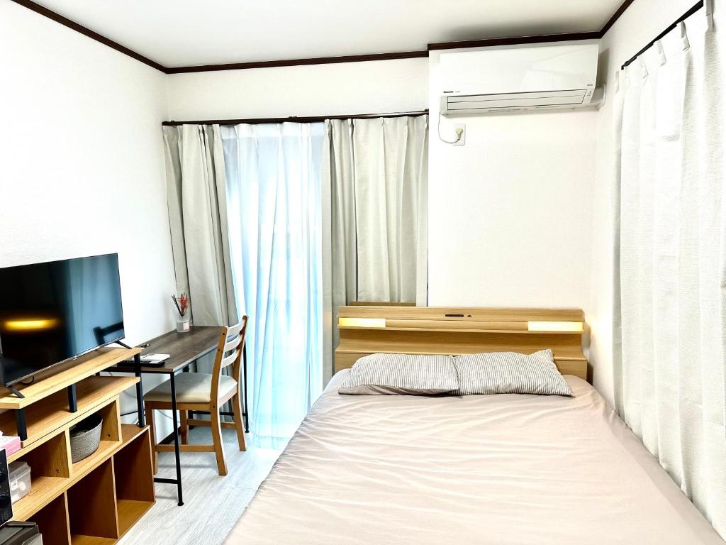 Кровать или кровати в номере Bon House Kanamachi Direct to Sensoji Skytree Disneyland Airport Free Parking