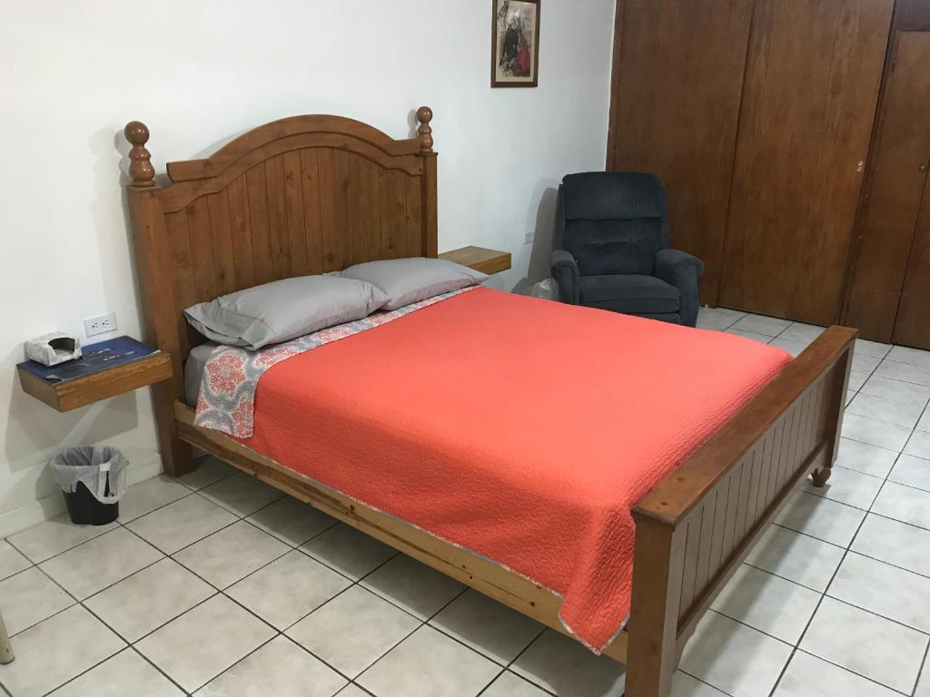 a bedroom with a bed and a chair in it at Prívate and quiet. in Chihuahua