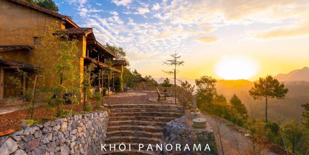 同文的住宿－Khói Panorama，通往一座建筑的石头小径,在后面有日落