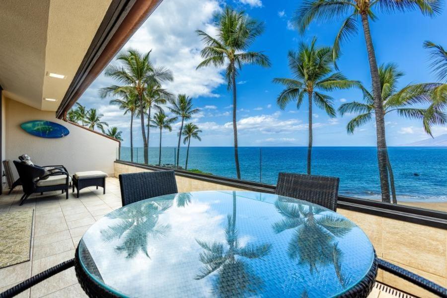 a dining room with a table and a view of the ocean at MAKENA SURF, #E-303 condo in Wailea
