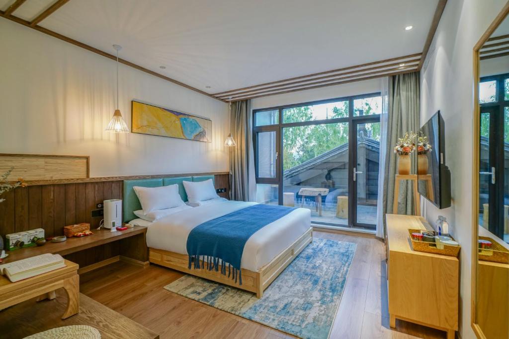 Postel nebo postele na pokoji v ubytování Xisu Garden Inn