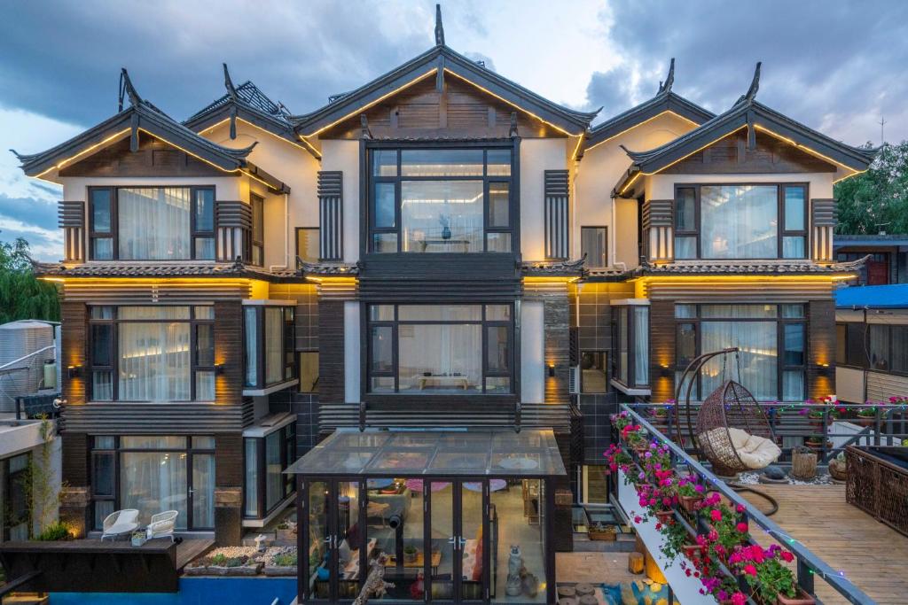 een groot huis met veel ramen bij Xisu Garden Inn Lijiang in Lijiang