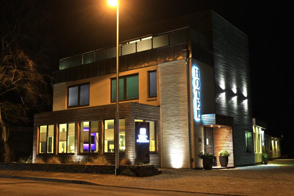 a building with a street light in front of it at Hotel Insel Pension in Niebüll