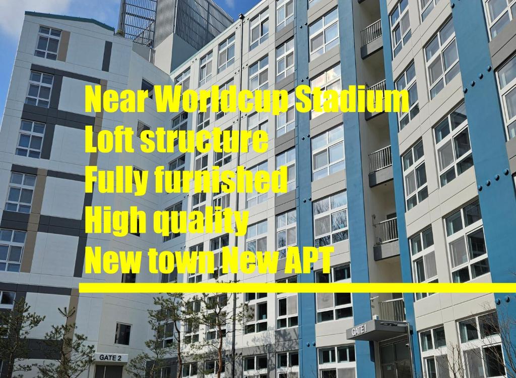 a tall building with yellow signs on it at Near DMC, Fully furnished, Loft sturcture, New APT in Goyang