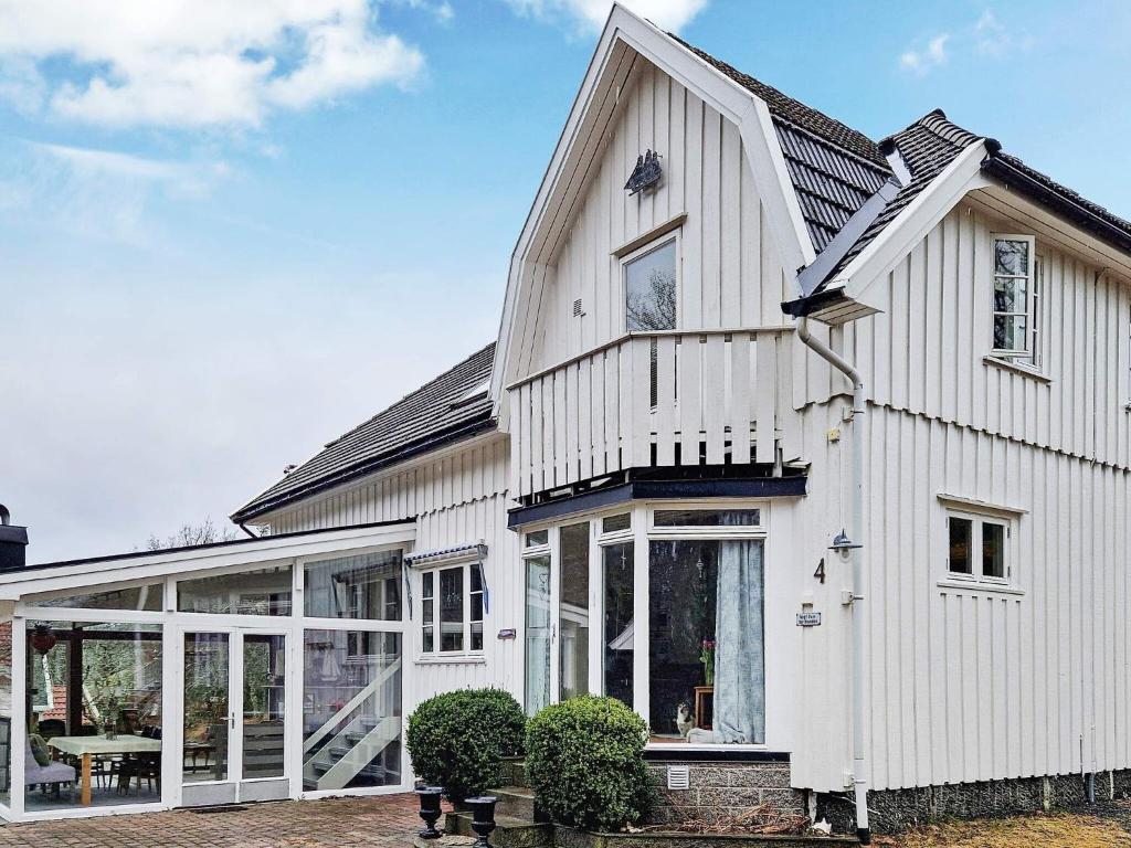 a white house with a conservatory and windows at Holiday home TJODALYNG 