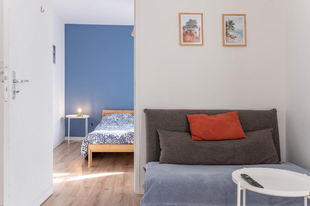 ein Wohnzimmer mit einem Sofa und einem Bett in der Unterkunft T2 Charmant - Segré centre ville - 003 in Segré