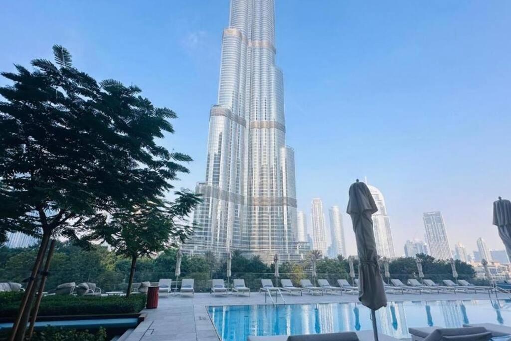 a large building with a pool in front of a city at 2Bed Dubai Address Opera Residence sea view - Downtown near Burj Khalifa- 5 min walk Dubai mall in Dubai