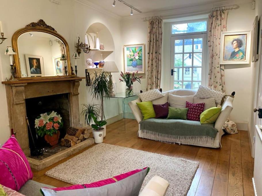 a living room with a couch and a fireplace at Fabulous Grade 2 Listed Home in Heart of Stow in Stow on the Wold