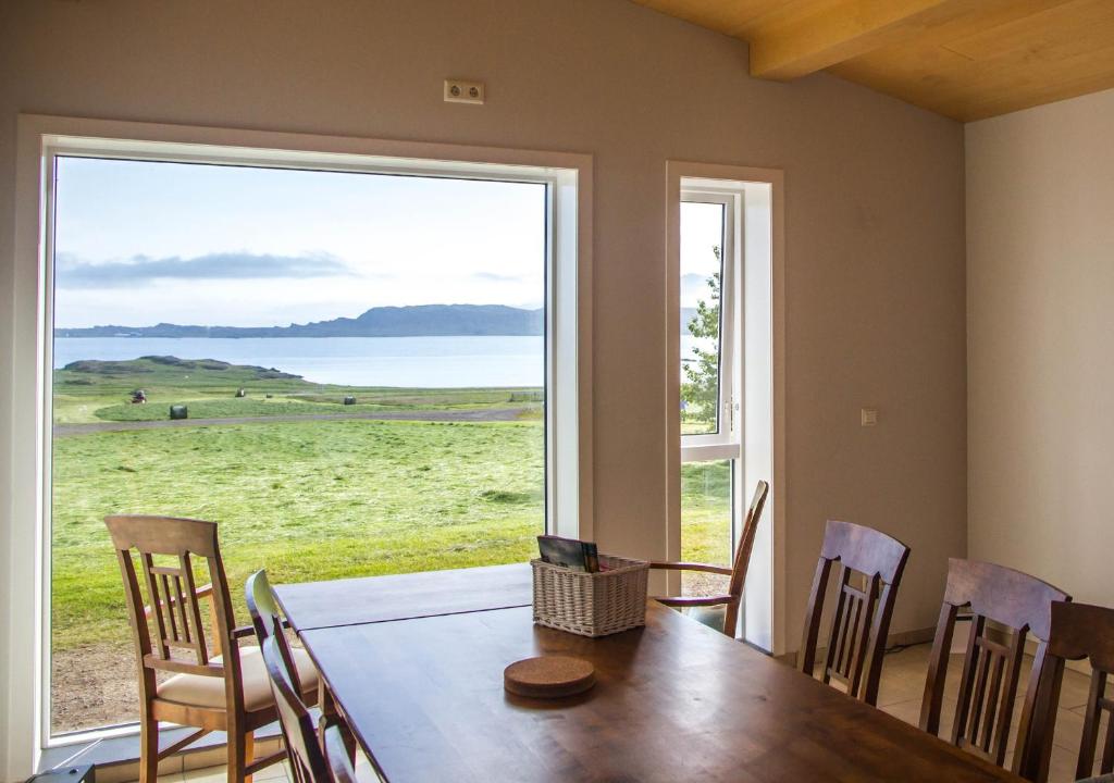 a dining room with a table and a large window at Berunes HI Hostel in Berunes