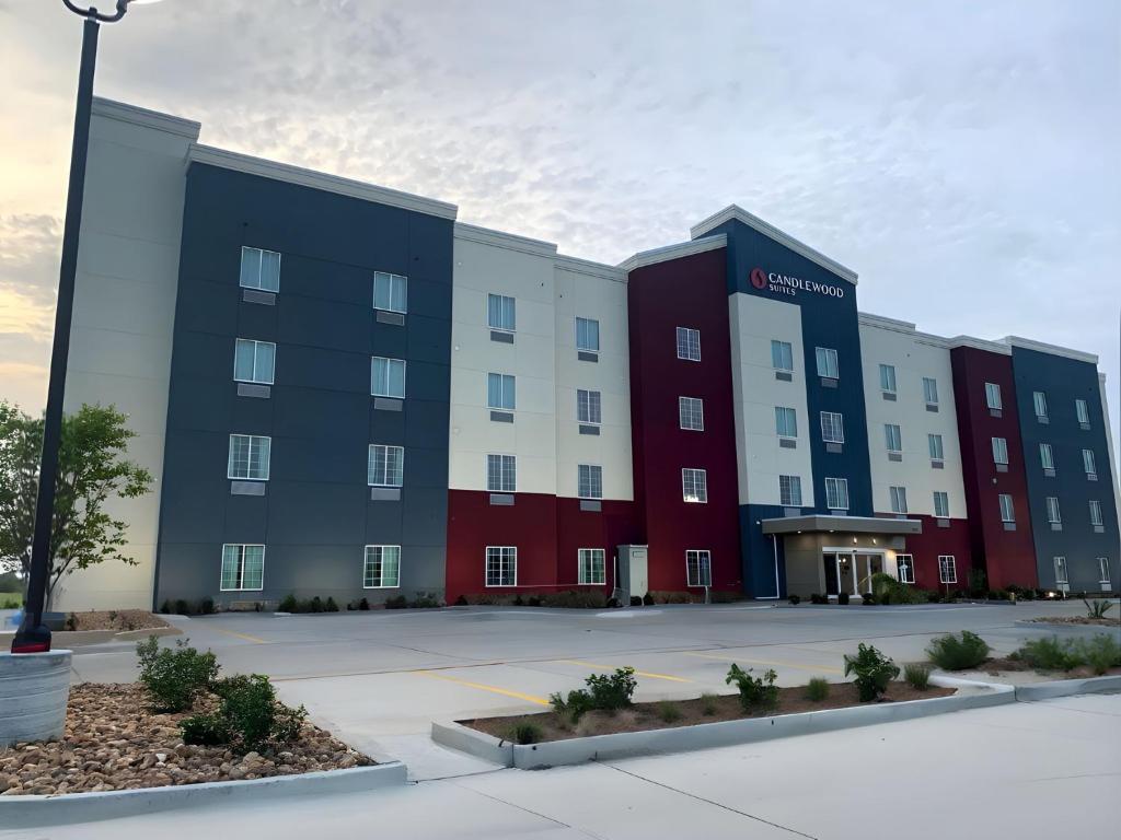 an apartment building with a red white and blue at Candlewood Suites - Corpus Christi - Portland, an IHG Hotel in Portland