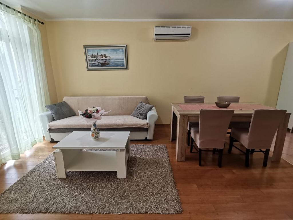 a living room with a couch and a table at Apartment Lučić in Poreč
