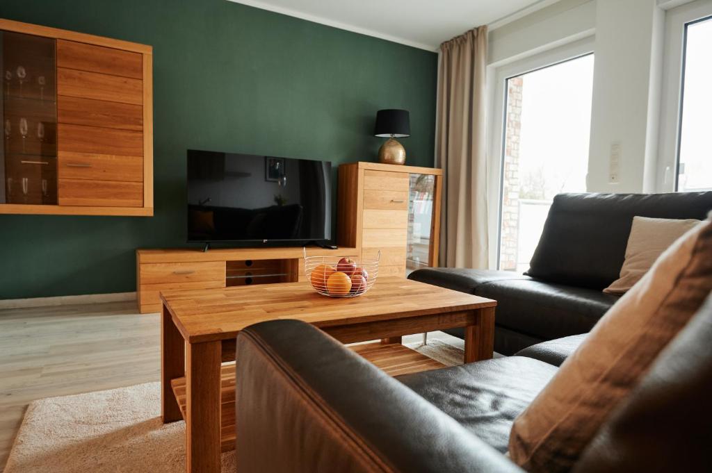 uma sala de estar com um sofá e uma televisão em Modernes Business Apartment in Weyhe Nähe Bremen em Weyhe