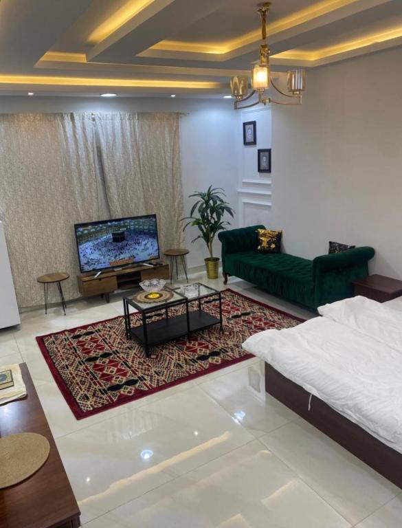a living room with a couch and a tv at استديو حي النزهه in Jeddah