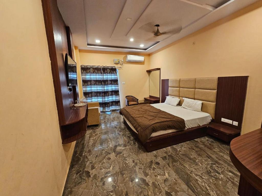 a bedroom with a bed in a room at Hotel Aditya Inn in Varanasi